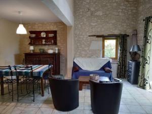 a living room with a table and a dining room at Le Vignal in Monflanquin