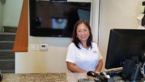 a woman sitting at a desk in front of a computer at Marin Lodge in San Rafael