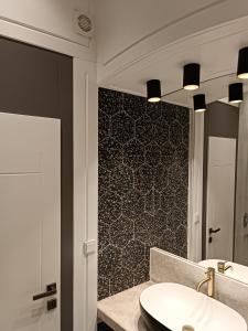 a bathroom with a sink and a mirror at Apartman Verde free parking in Sarajevo