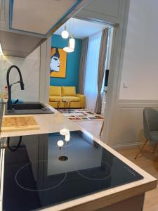 a kitchen and living room with a glass counter top at Apartman Verde free parking in Sarajevo