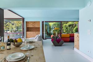 a living room with a table with wine glasses at Villa Vignola on Lake Como in Lenno