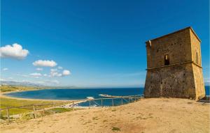 a building on top of a hill next to the ocean at Ciauru di Casa in Porto Palo +15 photos