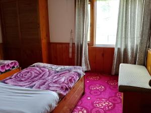 a bedroom with a bed and a pink carpet at Available for Kalam in Kalām