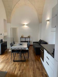 a living room with a table and a couch at Casa Maria in Grottaglie
