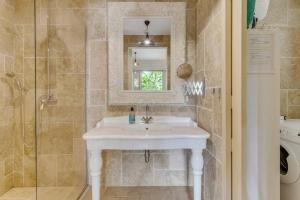 a bathroom with a white sink and a shower at Ocean Breeze Apartments #33 in Kralendijk +16 photos