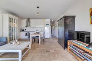 a living room with a table and a kitchen at Ocean Breeze Apartments #33 in Kralendijk