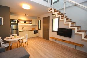 a kitchen and a living room with a staircase at The Thassian Yard Houses in Prinos