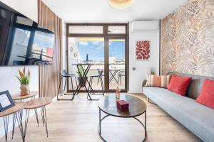 a living room with a couch and a table at BeachSide Maspalomas FKK friendly in Maspalomas