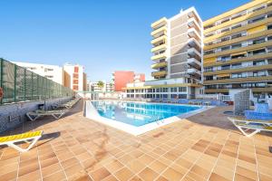 a swimming pool in the middle of a building at BeachSide Maspalomas FKK friendly in Maspalomas