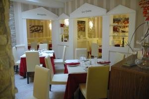 a dining room with tables and white chairs and tablesearcher at Hotel Ideal in Villarrobledo