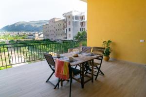 a table and chairs on a balcony with a view at Veranda sul Verde in Ficarazzi