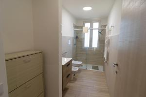a bathroom with a toilet and a sink and a shower at Veranda sul Verde in Ficarazzi +13 photos
