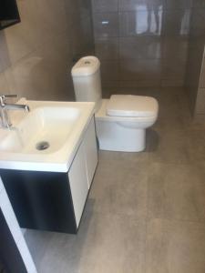 a bathroom with a white sink and a toilet at 82 Avenue D West, North Legon in North Legon