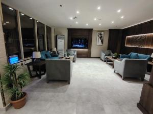 a lobby with couches and chairs in a building at همم للشقق المخدومة أملج-HMM Appartment Service in Umm Lajj