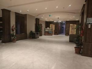 a lobby with potted plants in a building at همم للشقق المخدومة أملج-HMM Appartment Service in Umm Lajj