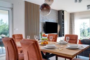 a dining room with a table and chairs at Villa Mihojka in Malinska