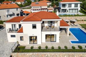 an aerial view of a house with a swimming pool at Villa Mihojka in Malinska
