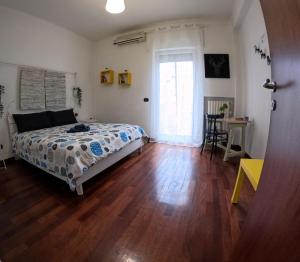 a bedroom with a bed and a wooden floor at De Rossi Holiday 'Rooms&Apartment' in Bari