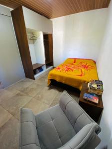a living room with a couch and a bed at Chácara de lazer Mandirituba in Rio da Várzea +28 photos