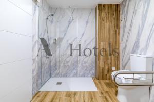 a bathroom with a shower and a toilet at AYZ Princesa-Auto check-in property in Madrid