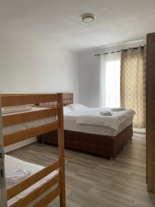 a bedroom with two bunk beds and a window at Darija in Dobra Voda