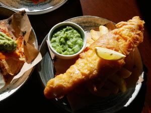 a plate of food with fish and chips and dip at Bulls Head, Castleton in Castleton