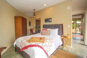 a bedroom with a bed with a tray on it at Executive 1 Bedroom Poolside Apt Kilele suite in Christiansted +11 photos