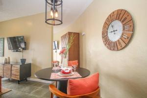 a dining room with a table and a clock on the wall at Executive 1 Bedroom Poolside Apt Kilele suite in Christiansted
