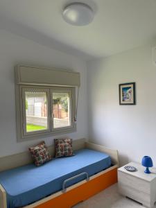 a bed in a room with a window at Villa Baia del Silenzio in Agnone Bagni