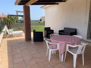 a patio with a table and chairs on a patio at Villa Baia del Silenzio in Agnone Bagni
