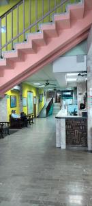 a large room with a staircase with pink stairs at Hoteles Santa Regina in Chihuahua