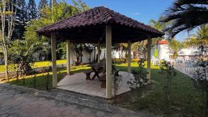 a gazebo with a picnic table in a park at Hotel e Pousada Recanto do mar in Florianópolis