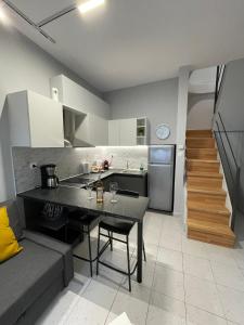 a kitchen and a living room with a table and a couch at House of Memories in Nea Chili