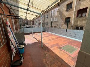 an empty tennis court with a tennis court at Peris in Gijón