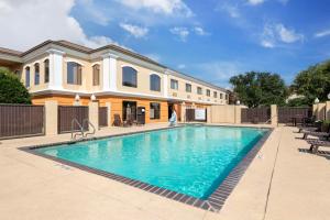 a swimming pool in front of a house at Best Western Inn & Suites New Braunfels in New Braunfels