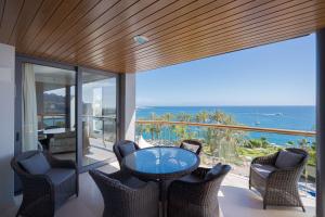 d'un balcon avec une table et des chaises donnant sur l'océan. dans l'établissement Radisson Blu Resort Gran Canaria, à Playa de Arguineguín