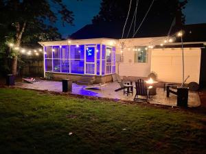 ein Haus mit violetten Lichtern auf einer Terrasse bei Nacht in der Unterkunft Peaceful home in downtown Huntsville with nice back patio! in Huntsville
