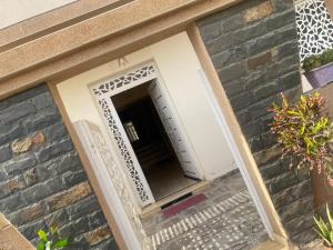 Una puerta de entrada a un edificio con un muro de piedra. en Hote houda, en Tazrout