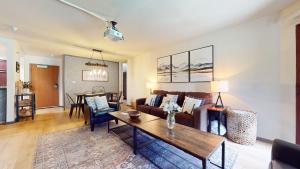 a living room with a couch and a table at Aspen Creek #115 in Mammoth Lakes