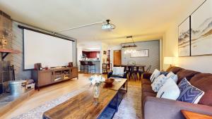 a living room with a couch and a table at Aspen Creek #115 in Mammoth Lakes