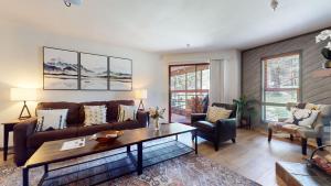 a living room with a couch and a table at Aspen Creek #115 in Mammoth Lakes