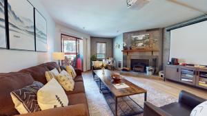 a living room with a couch and a table at Aspen Creek #115 in Mammoth Lakes