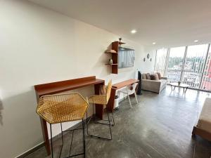 a living room with a table and chairs at S805- Apartaestudio loft en el norte de Armenia in Armenia +20 photos