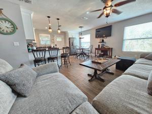 a living room with a couch and a table at El Palmar Cottages LLC Whole House in Clearwater Beach