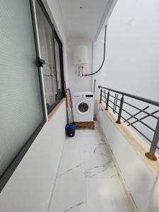 a bathroom with a washing machine in a room at Appart moderne nador al jadid près de la corniche in Nador +19 photos