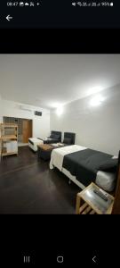 una habitación con dos camas y una mesa en Mansão Fazendinha para grupos Arraial do Cabo, en Arraial do Cabo