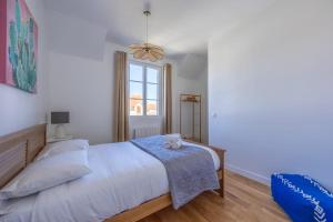 a bedroom with a large bed and a window at La Maison du Fleuve - Welkeys in Dives-sur-Mer