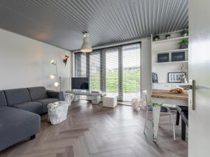 a living room with a couch and a table at Beachhouse I in Bergen aan Zee