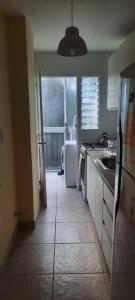 a kitchen with a sink and a refrigerator at Hermoso departamento en Palermo muy luminoso in Buenos Aires +7 photos