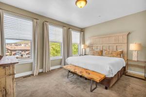 a bedroom with a large bed and windows at Charming 3BR-Near Skiing & Hiking in Kamas
